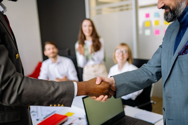 Handshake in an office representing signing with an acting agent