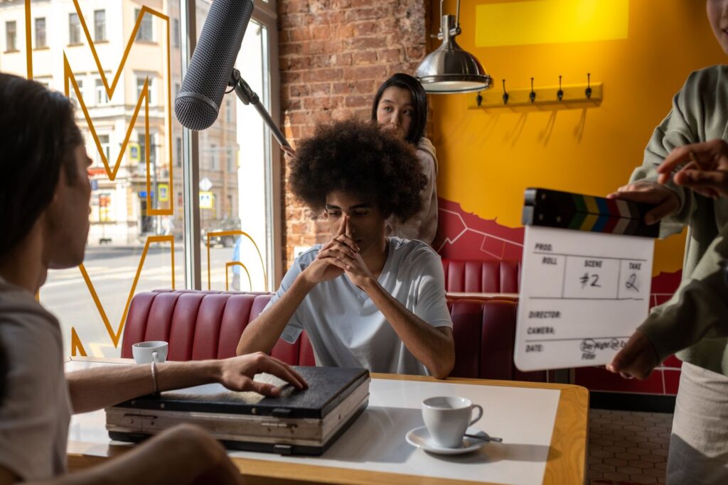 Film crew shooting a scene with clapperboard and boom mic
