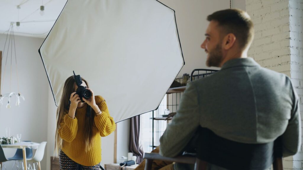 Photographer shooting a portrait with softbox lighting