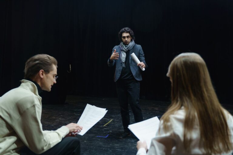 Actors and director rehearsing in a theater
