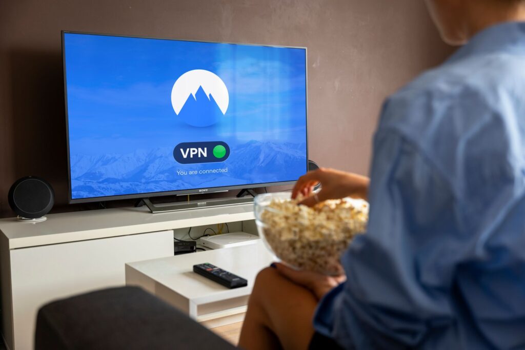 Person with popcorn watching a show at home